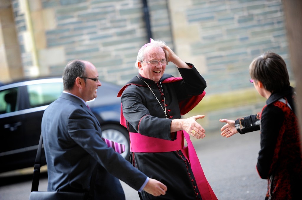 Bishop McKeown keeps his zucchetto despite the wind.