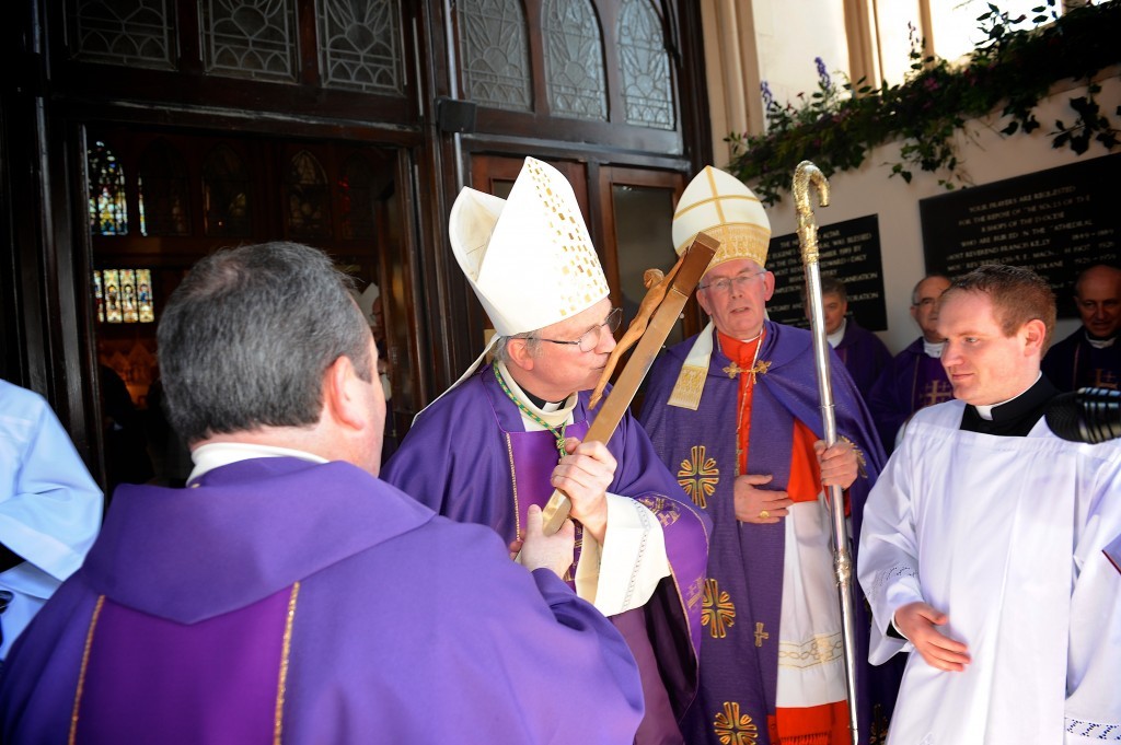 Bishop McKeown kisses the Crucifix on entering St Eugene's Cathedral