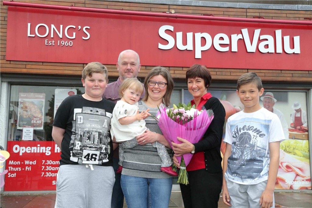 Dawn is pictured with her family and Donna Caldwell, store manager of SuperValu Newbuildings.